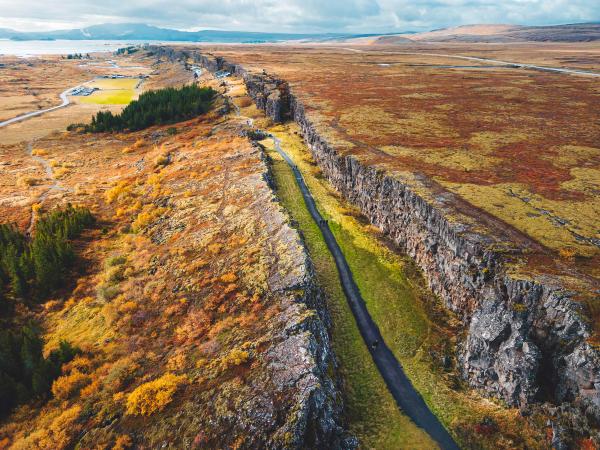 an aerial view of a road going through a rocky landscape .