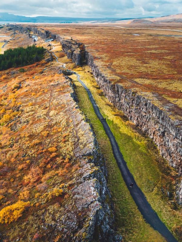 an aerial view of a road going through a rocky landscape .