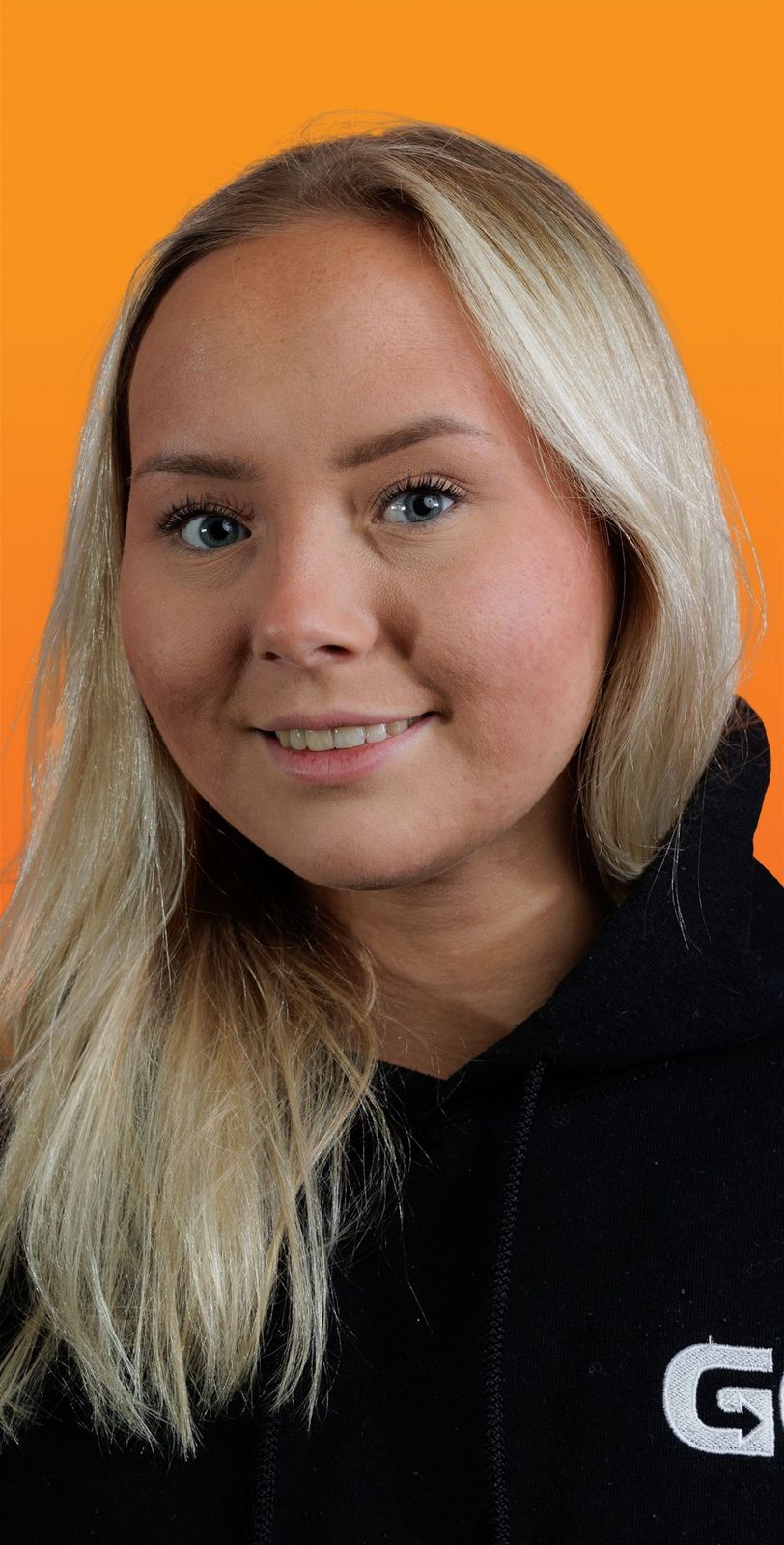a woman wearing a black hoodie with the letter g on it