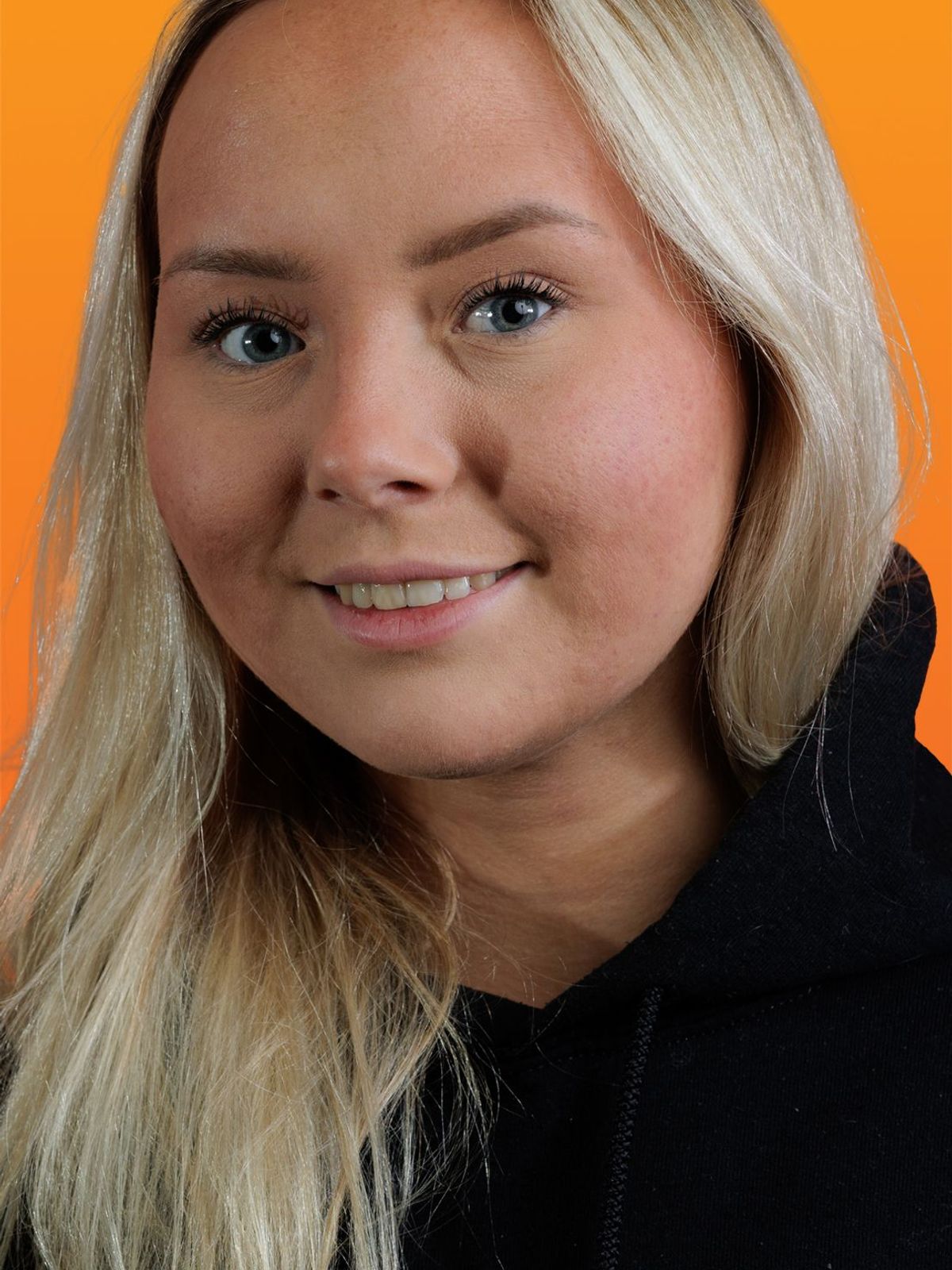 a woman wearing a black hoodie with the letter g on it