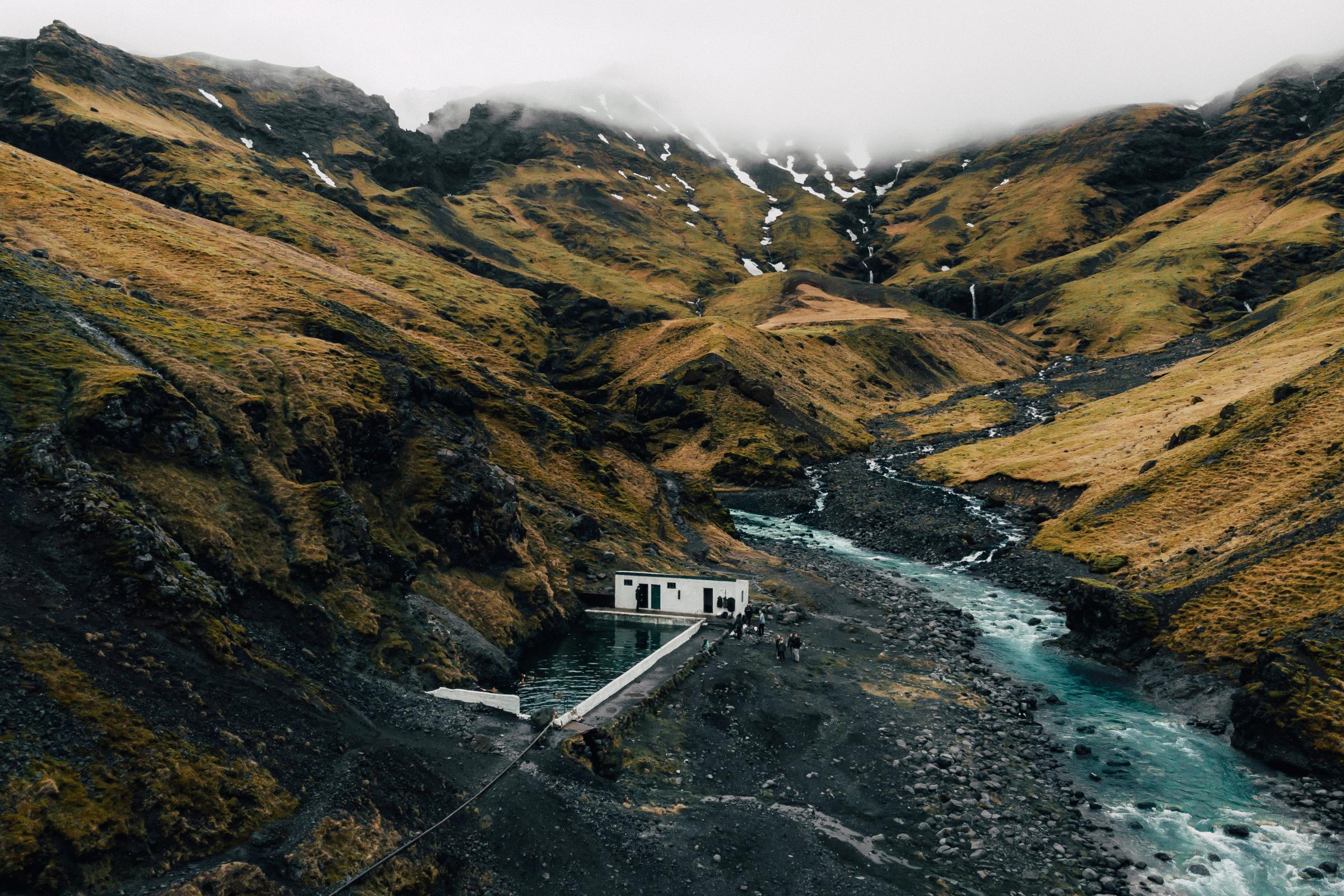 Natural hot spring pool in the mountains of Iceland at fall