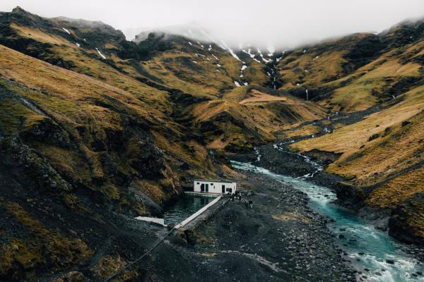 Natural hot spring pool in the mountains of Iceland at fall