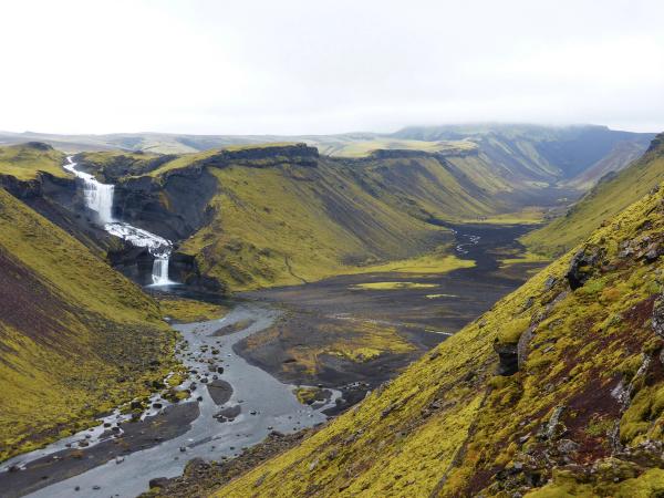 there is a waterfall in the middle of a valley, Eldgjá