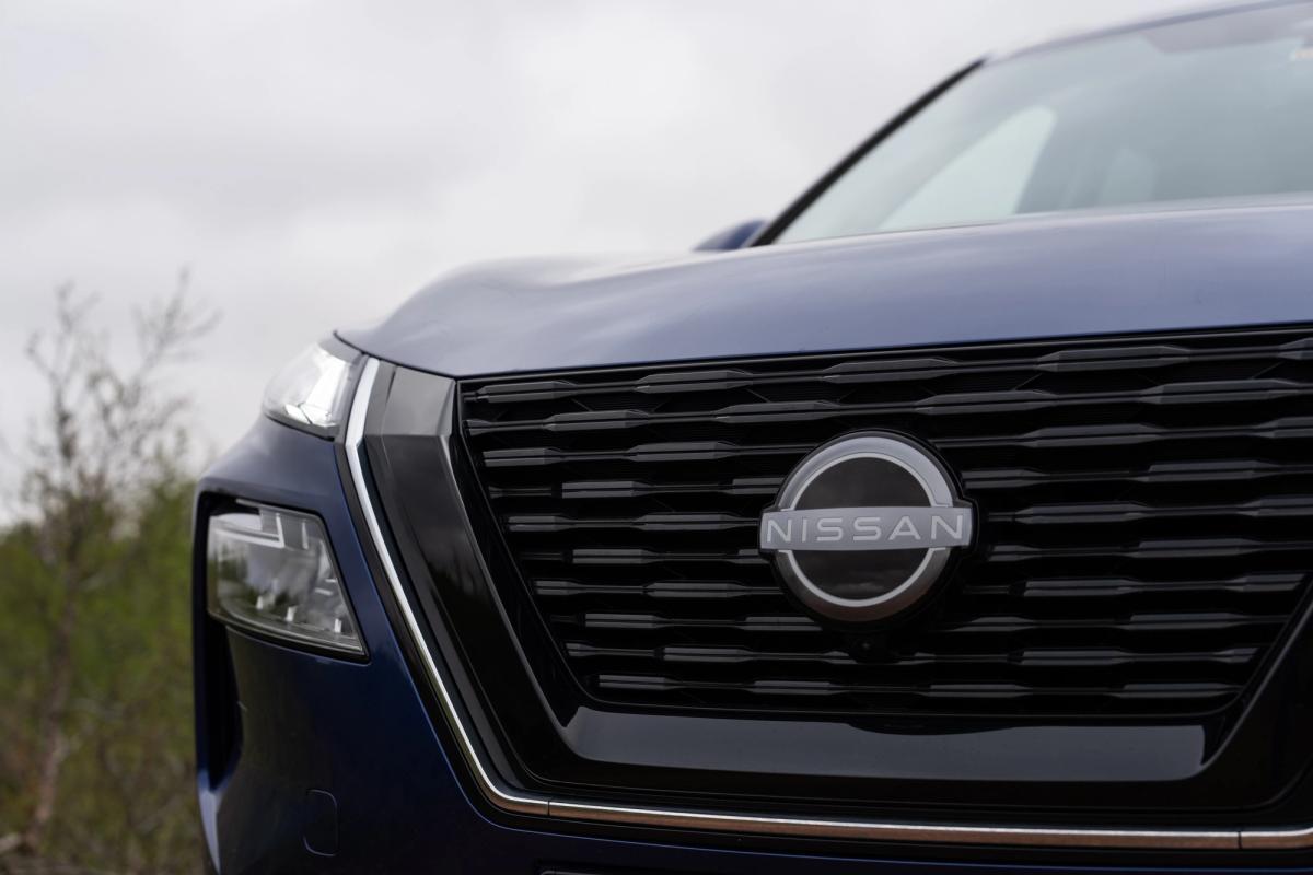 Nissan X-Trail close up of front grille and headlight with Nissan badge