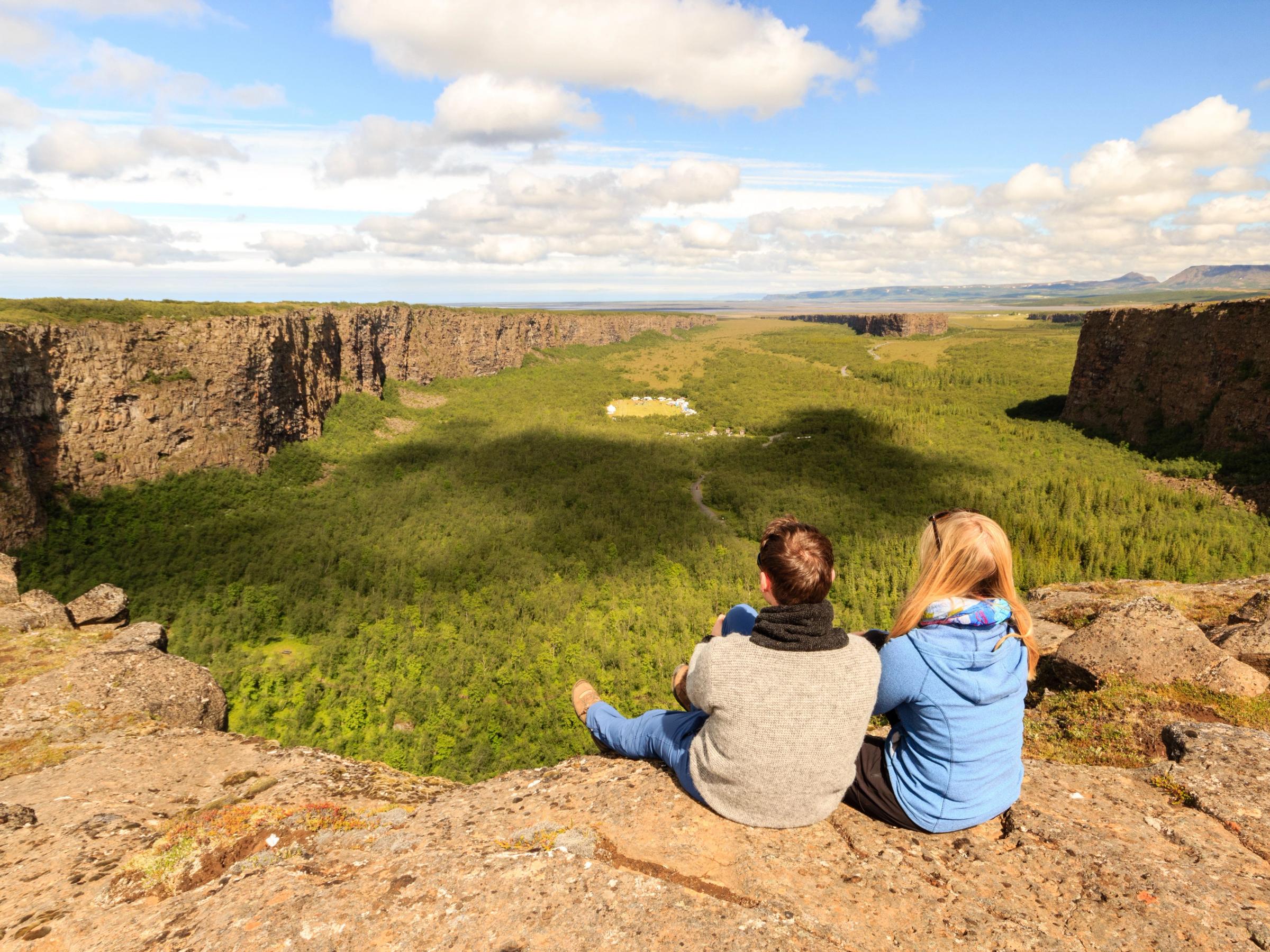 Hiking admiring the stunning view of Ásbyrgi Canyon, North Iceland