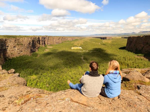 Couple watching Asbyrgi canyon from above