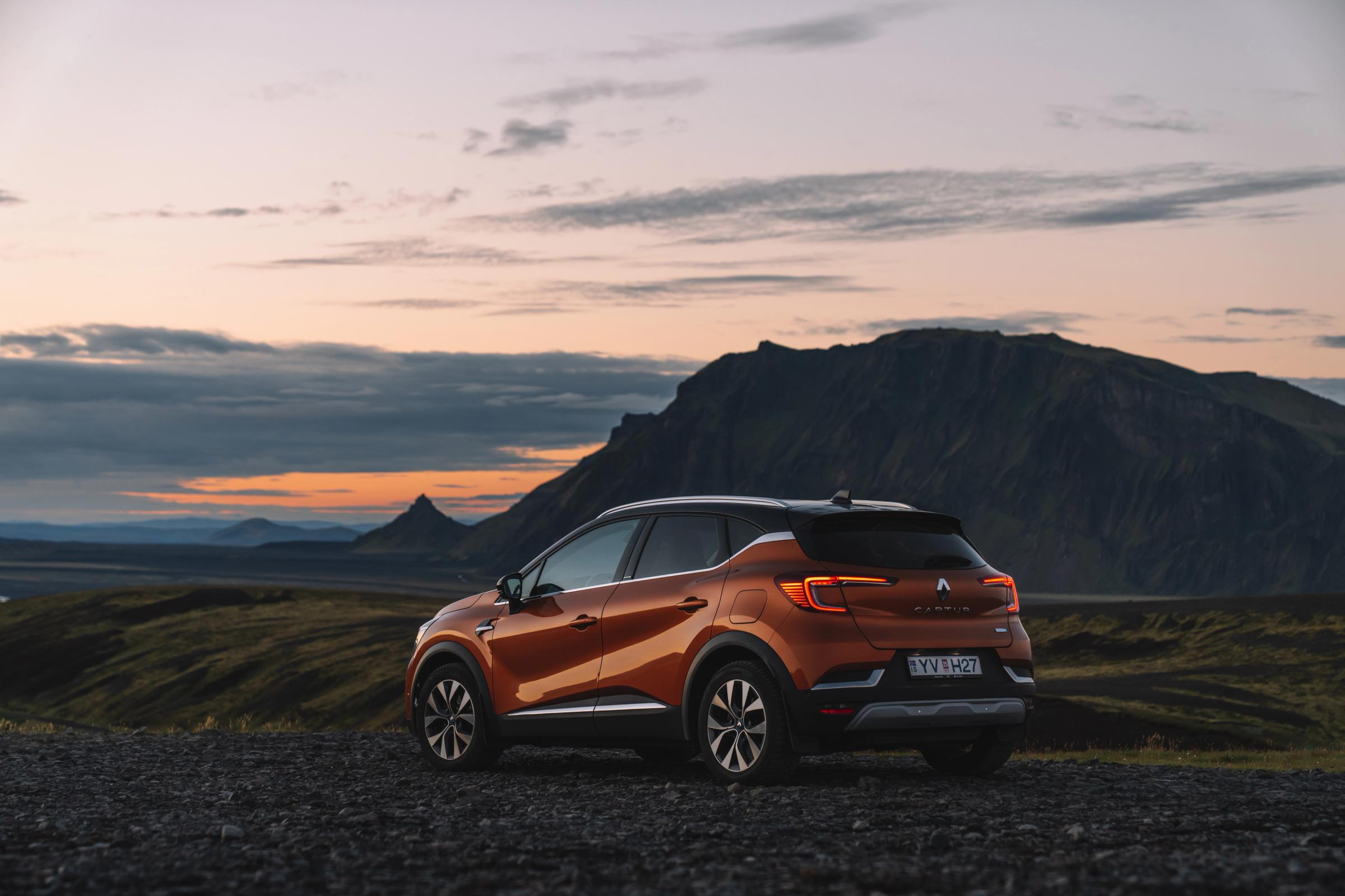 Renault Captur rear quarter view parked on gravel with mountain silhouettes at dusk