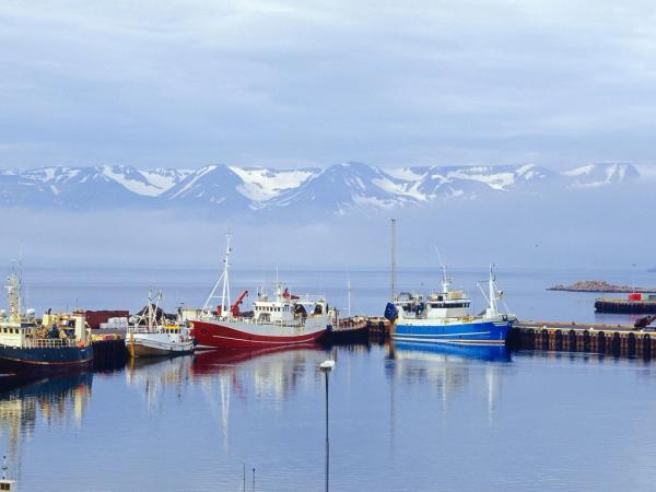 Husavik Harbor with the mountains on the background