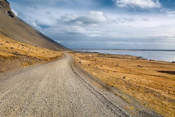 Travel the path less taken on Iceland's captivating gravel roads A long, winding gravel road meandering through the stark landscapes of Iceland