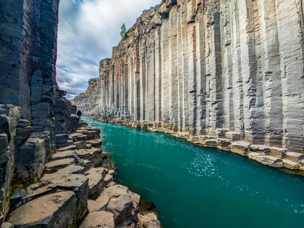 a river flowing through a canyon surrounded by rocks and water .
