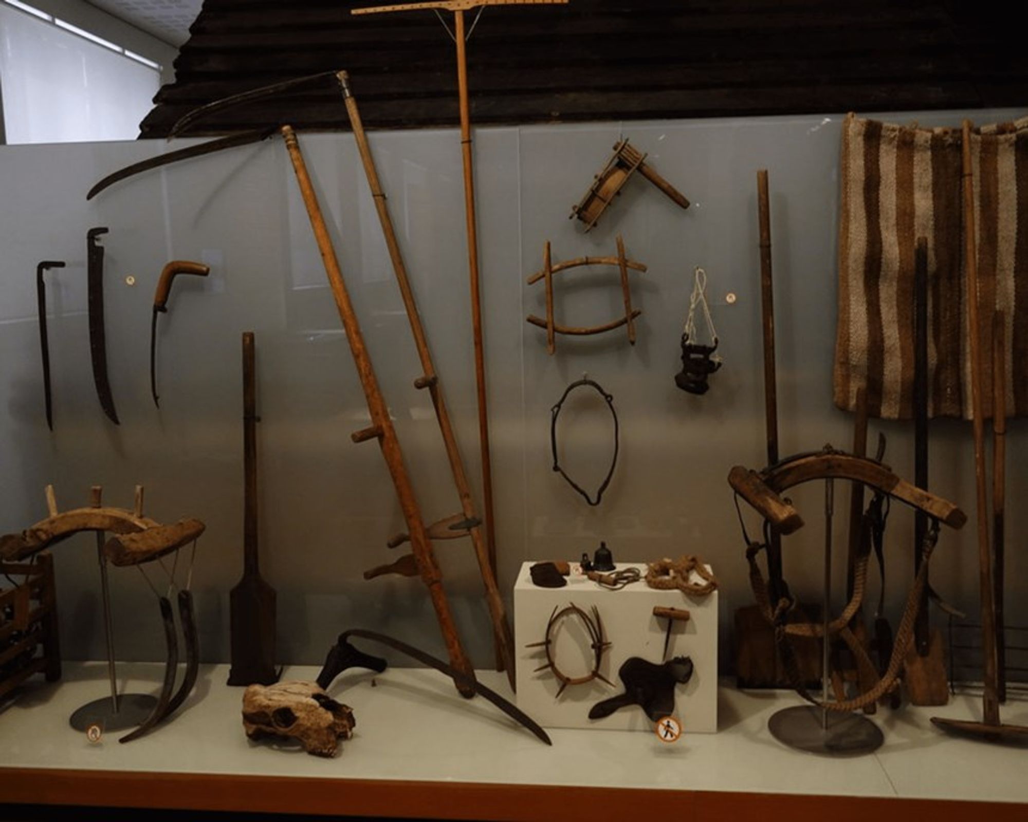 a variety of old farming tools are on display in a museum at National museum of Iceland in downtown Reykjavík.