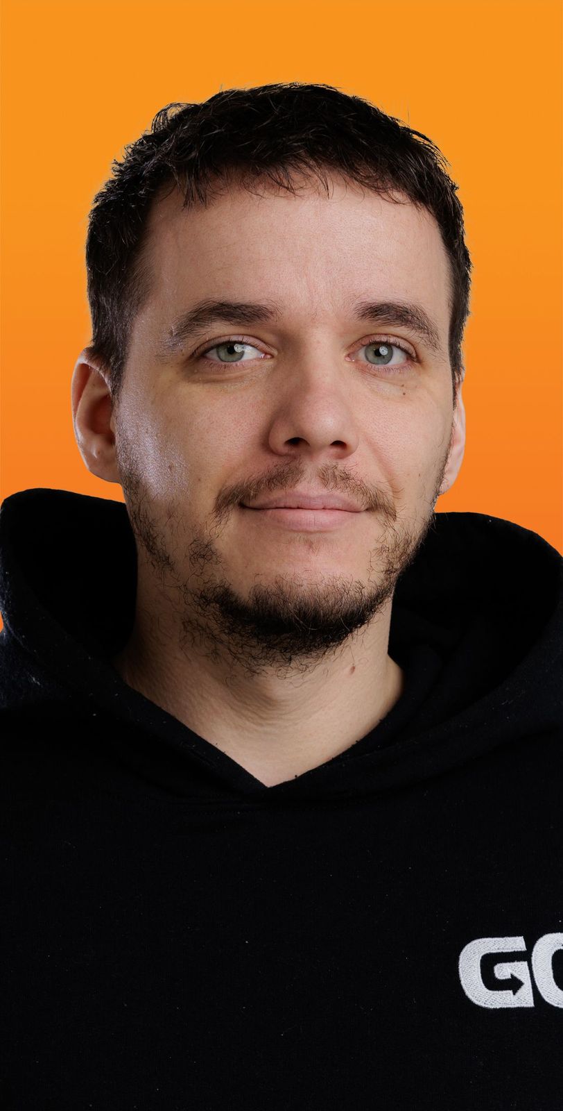 a man wearing a black hoodie with the letter go on it
