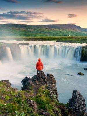 Tourist admiring Godafoss Waterfall