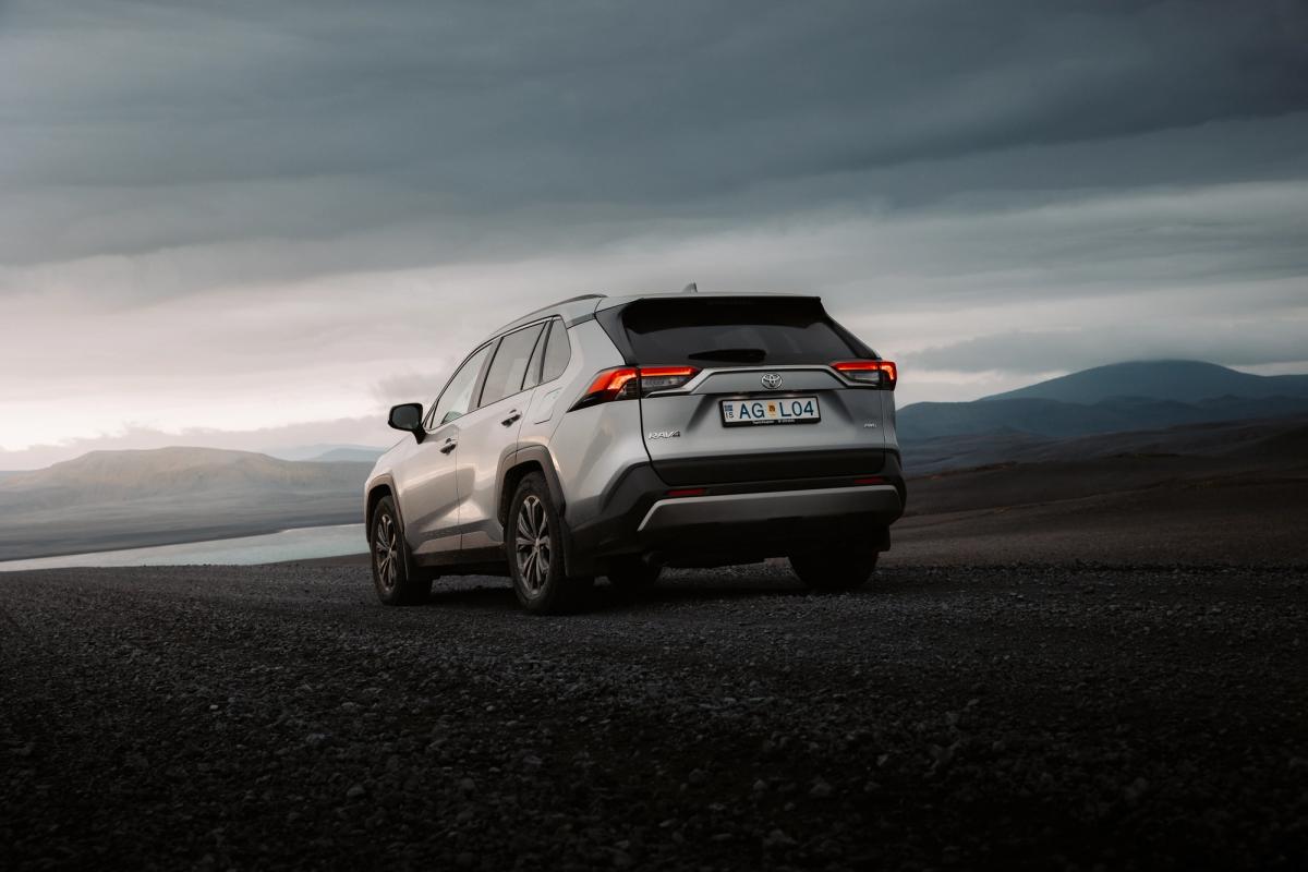 Toyota RAV4 rear three quarter view parked on gravel above a river valley
