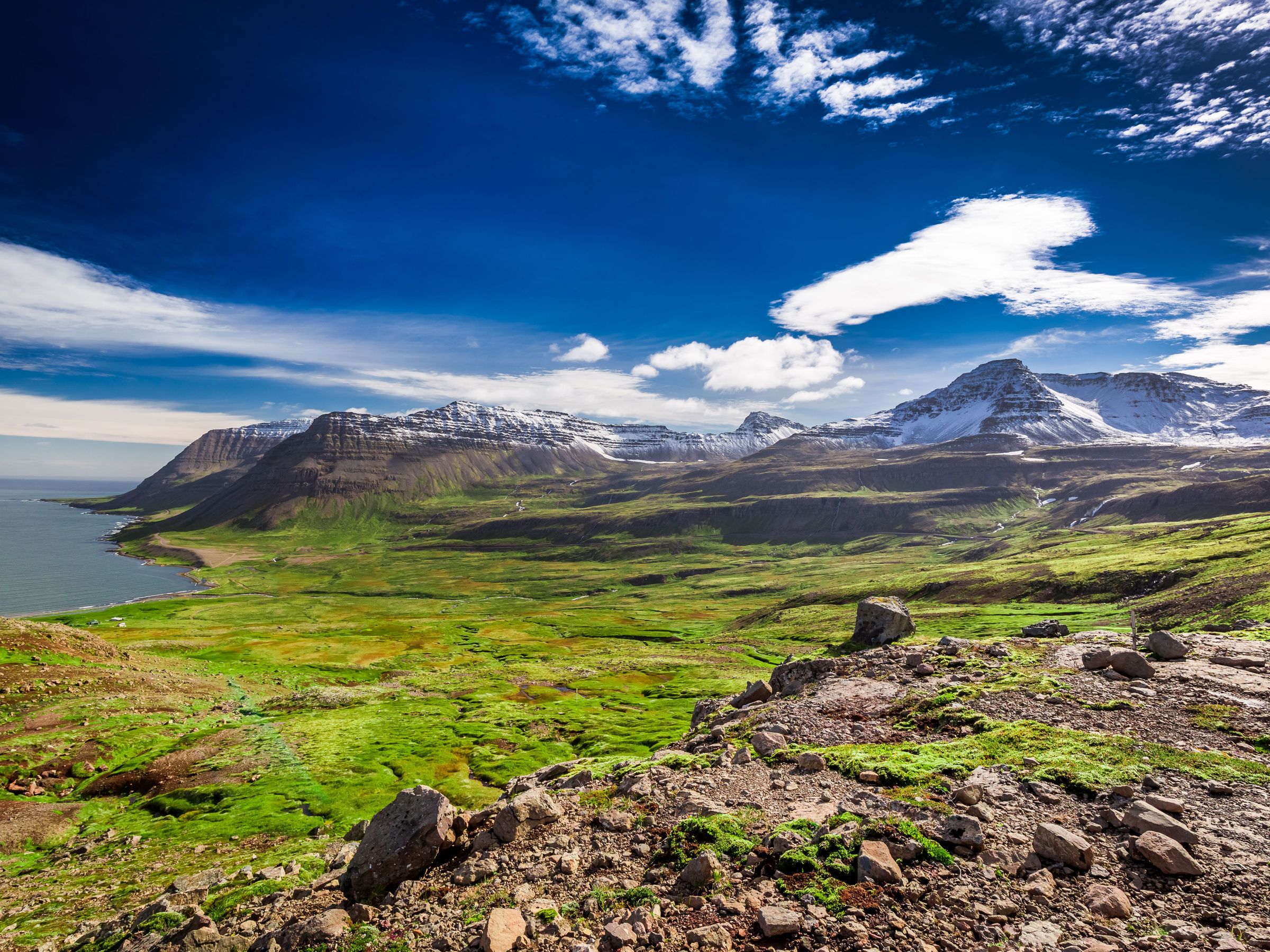 Huge green valley near the sea surrounded by mountains