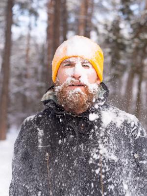 Adult man completely covered in snow