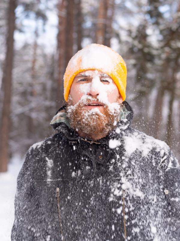 Adult man completely covered in snow