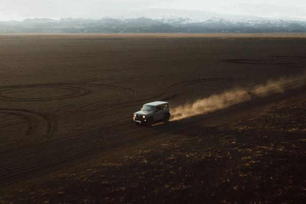 Navigating the rugged Icelandic terrain: A 4x4 rental car traverses an F-road A 4x4 rental car maneuvering along an F-road in the wild landscapes of Iceland