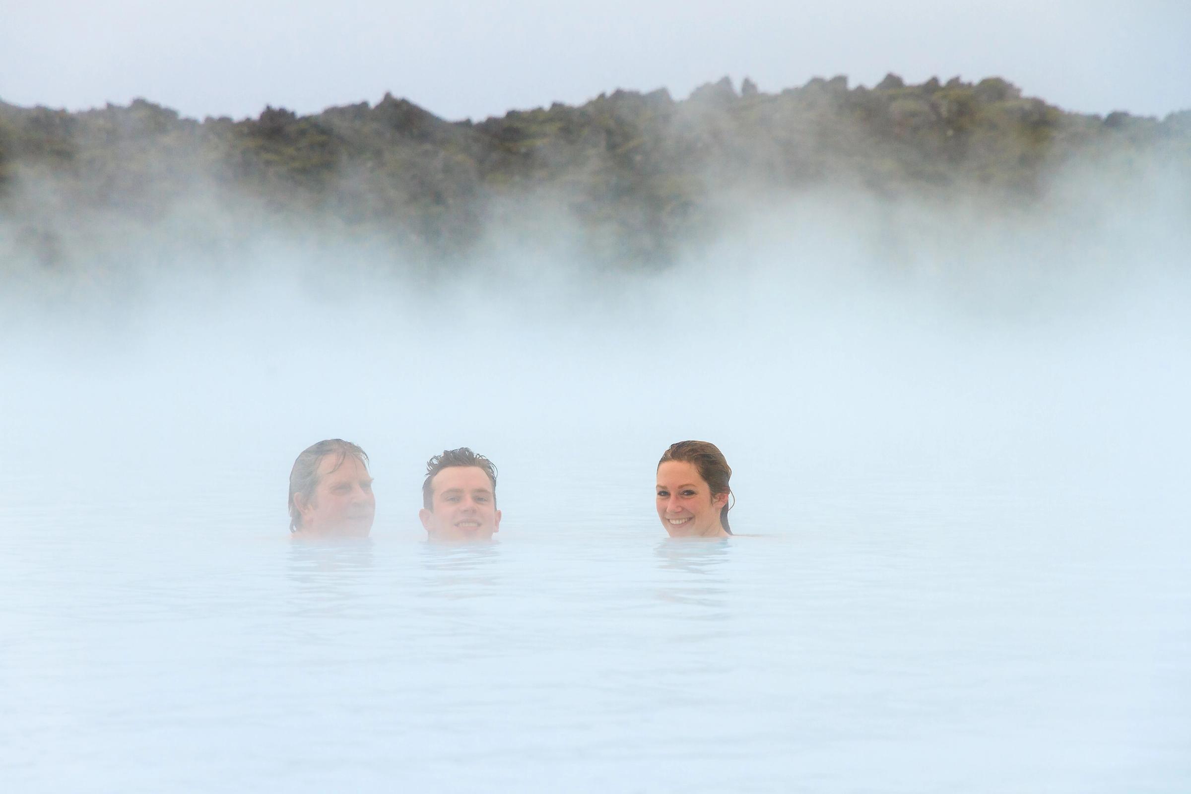 3 people having a good time in one of the many hot springs in Iceland