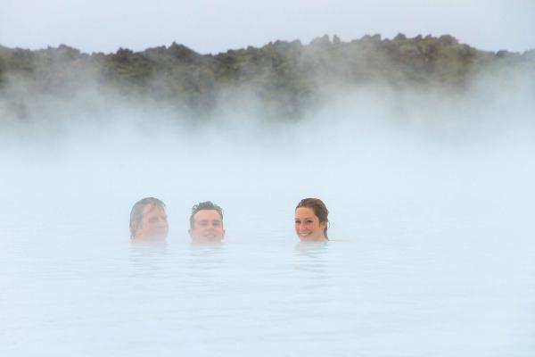 people in a hot spring in Iceland 3 people having a good time in one of the many hot springs in Iceland