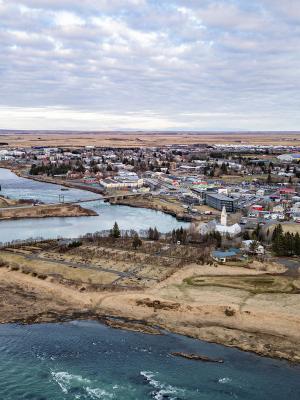 an aerial view of a city surrounded by water and a river .