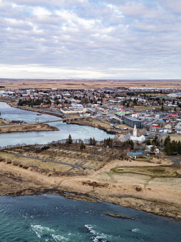an aerial view of a city surrounded by water and a river .
