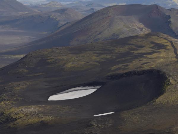 a landscape with black sand hills
