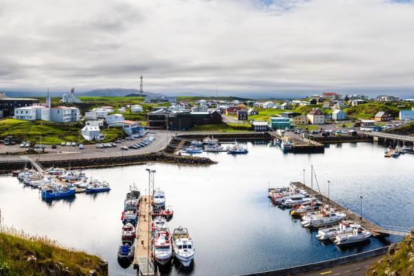a panoramic view of a harbor with boats docked in it .