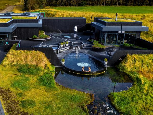 Aerial view of Krauma Spa's Pools surrounded by green