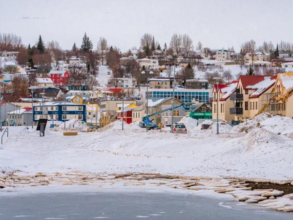 a town with colorful houses covered by snow