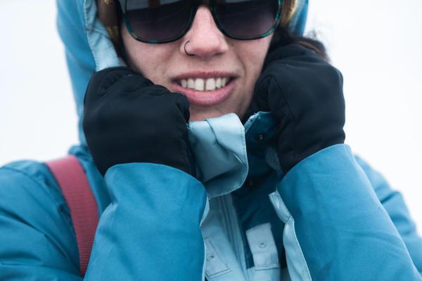 a woman wearing a blue jacket and a yellow hat