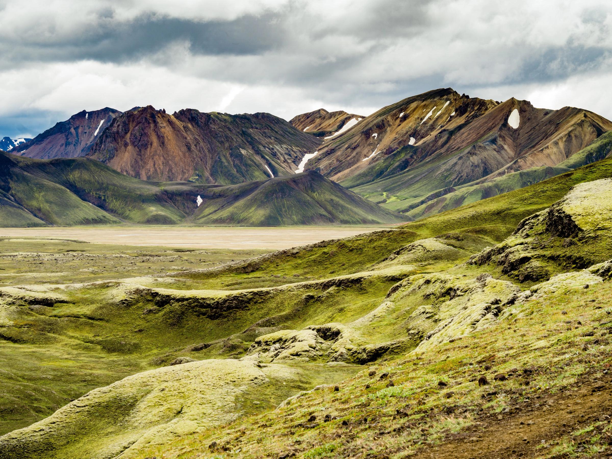 there are mountains in the background and a valley in the foreground .