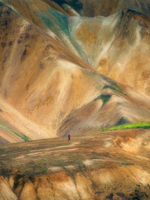 a person is walking on Landmannalaugar