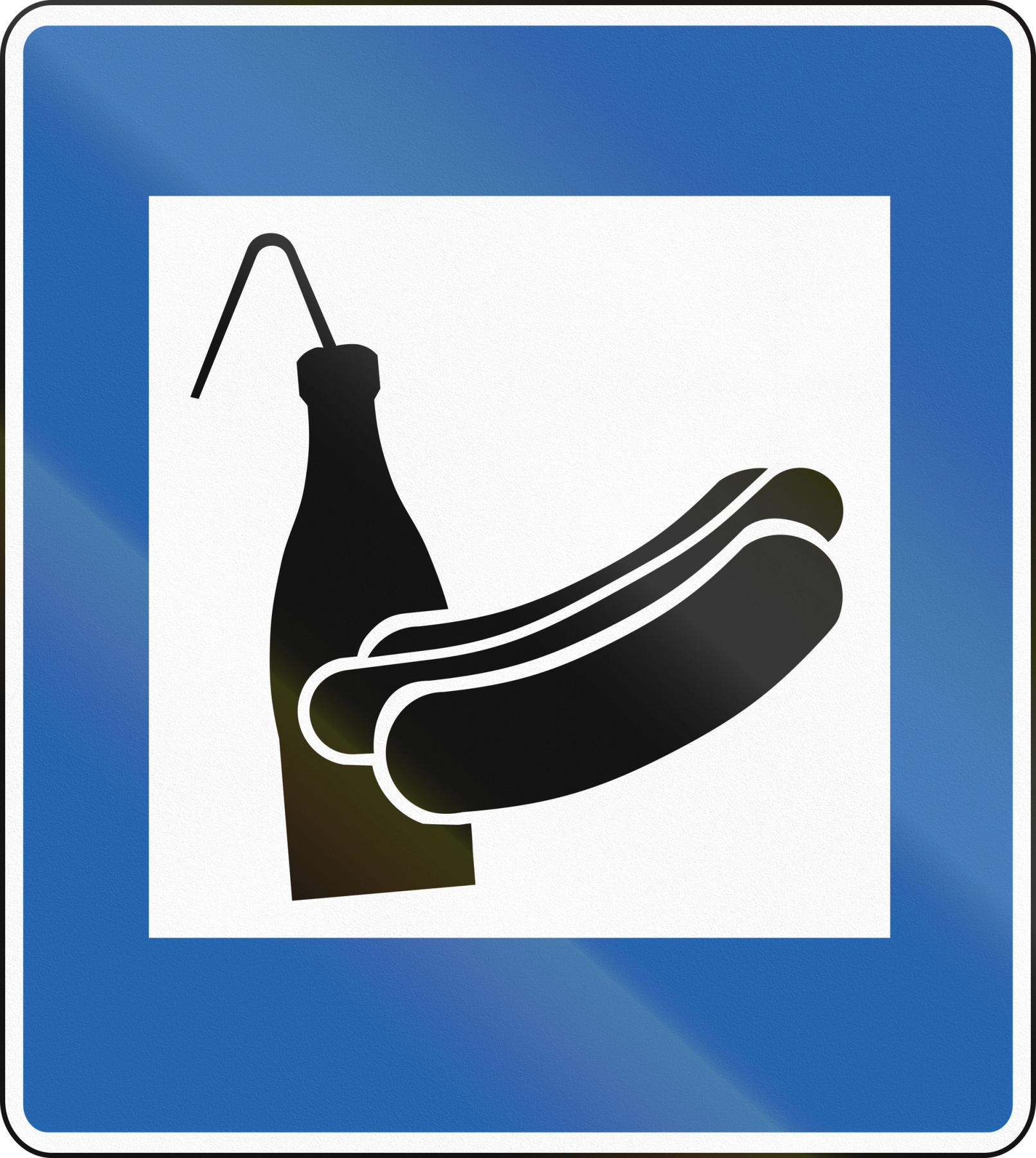 a blue sign with a hot dog and a bottle of ketchup