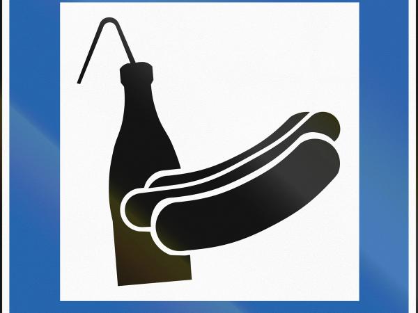 a blue sign with a hot dog and a bottle of ketchup