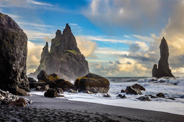 there are a lot of rocks on the beach and in the ocean .
