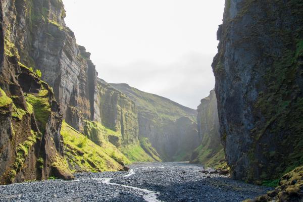 a river running through a canyon between two mountains .