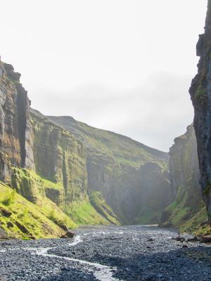 a river running through a canyon between two mountains .