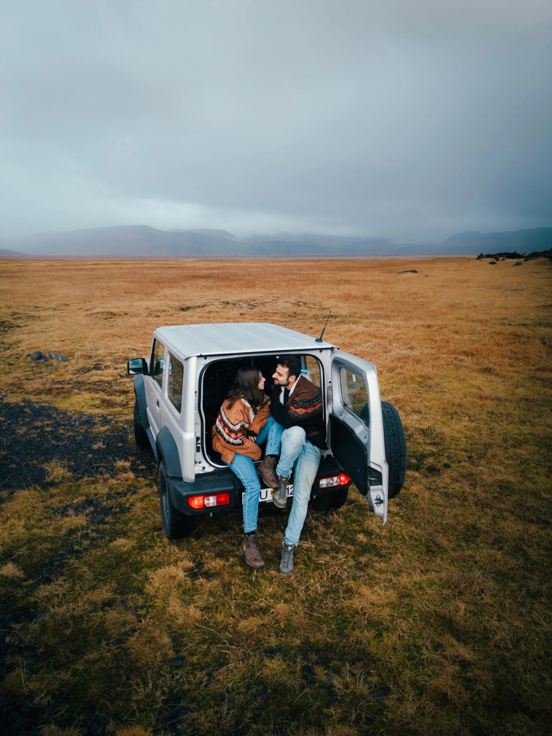 a man and a woman are sitting in the back of a car .