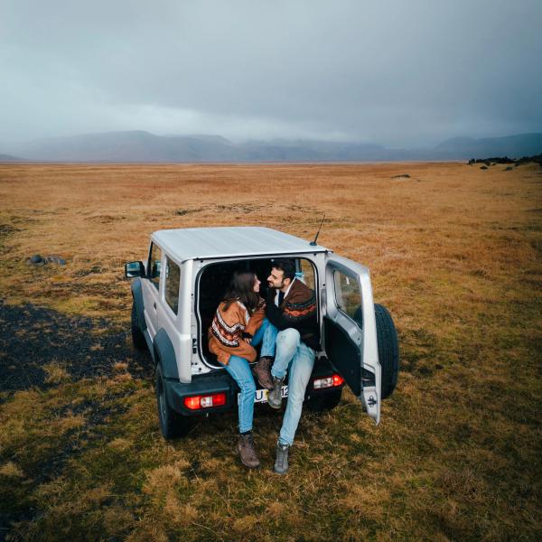 a man and a woman are sitting in the back of a car .