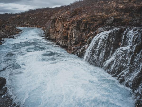 there is a waterfall in the middle of a river .