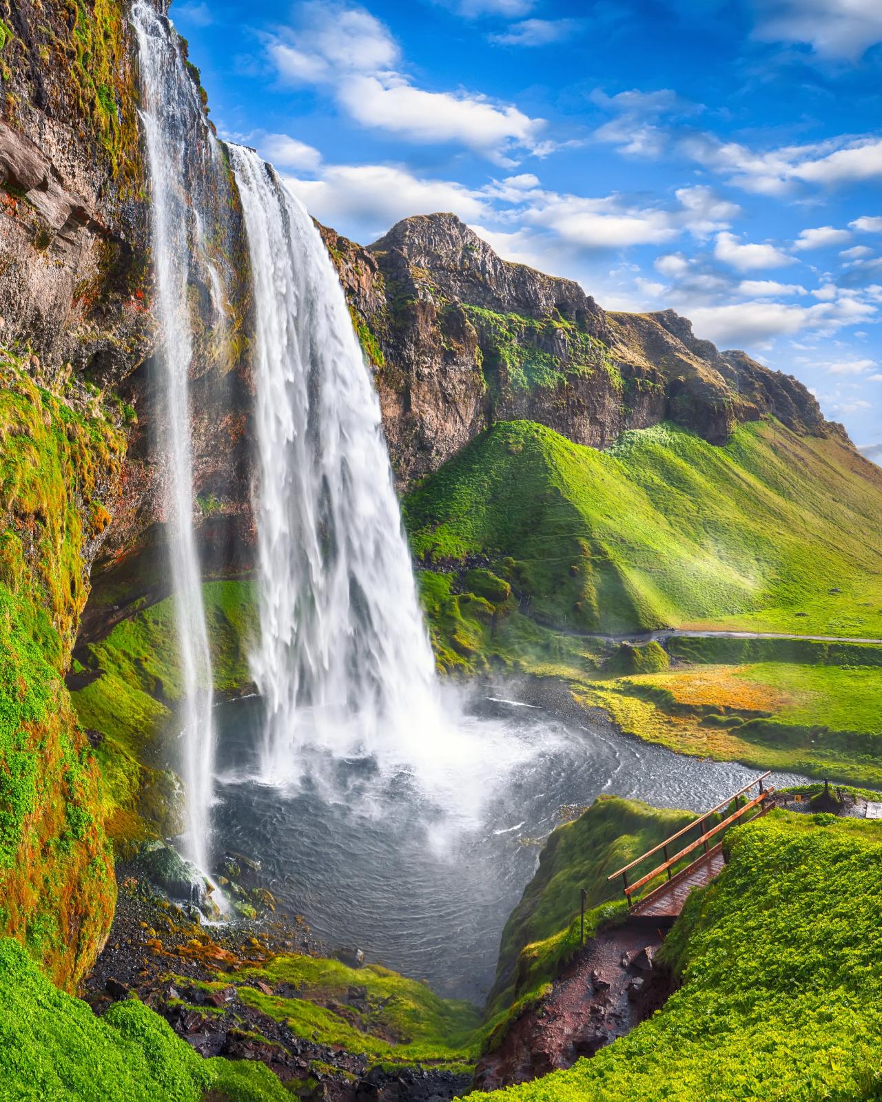 a waterfall falling into a pond