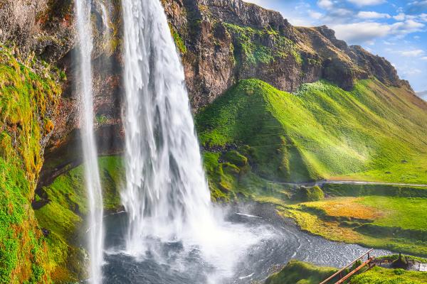 a waterfall falling into a pond