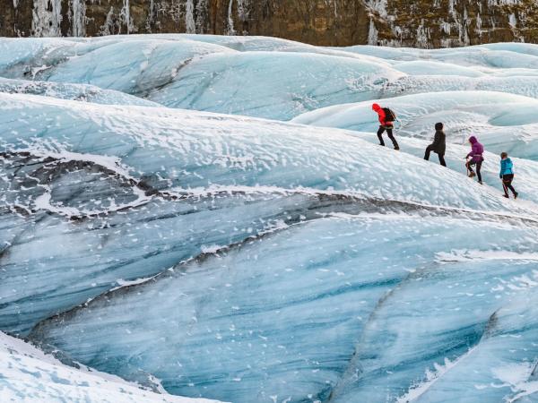 4 people hiking on a glacier in iceland