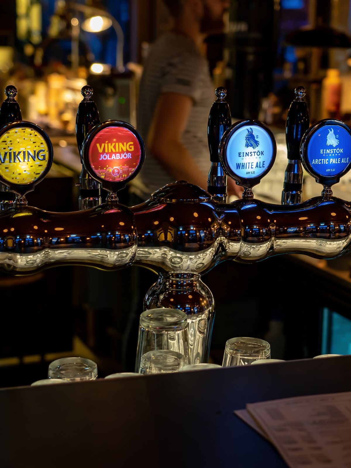 Six illuminated beer taps with "Viking" and "Einstok" branding line a bar.
