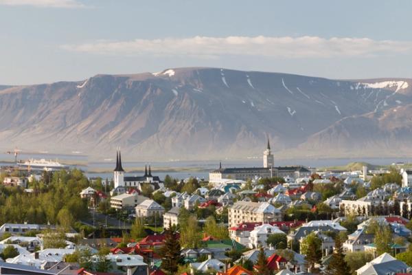 an aerial view of a city with a mountain in the background .