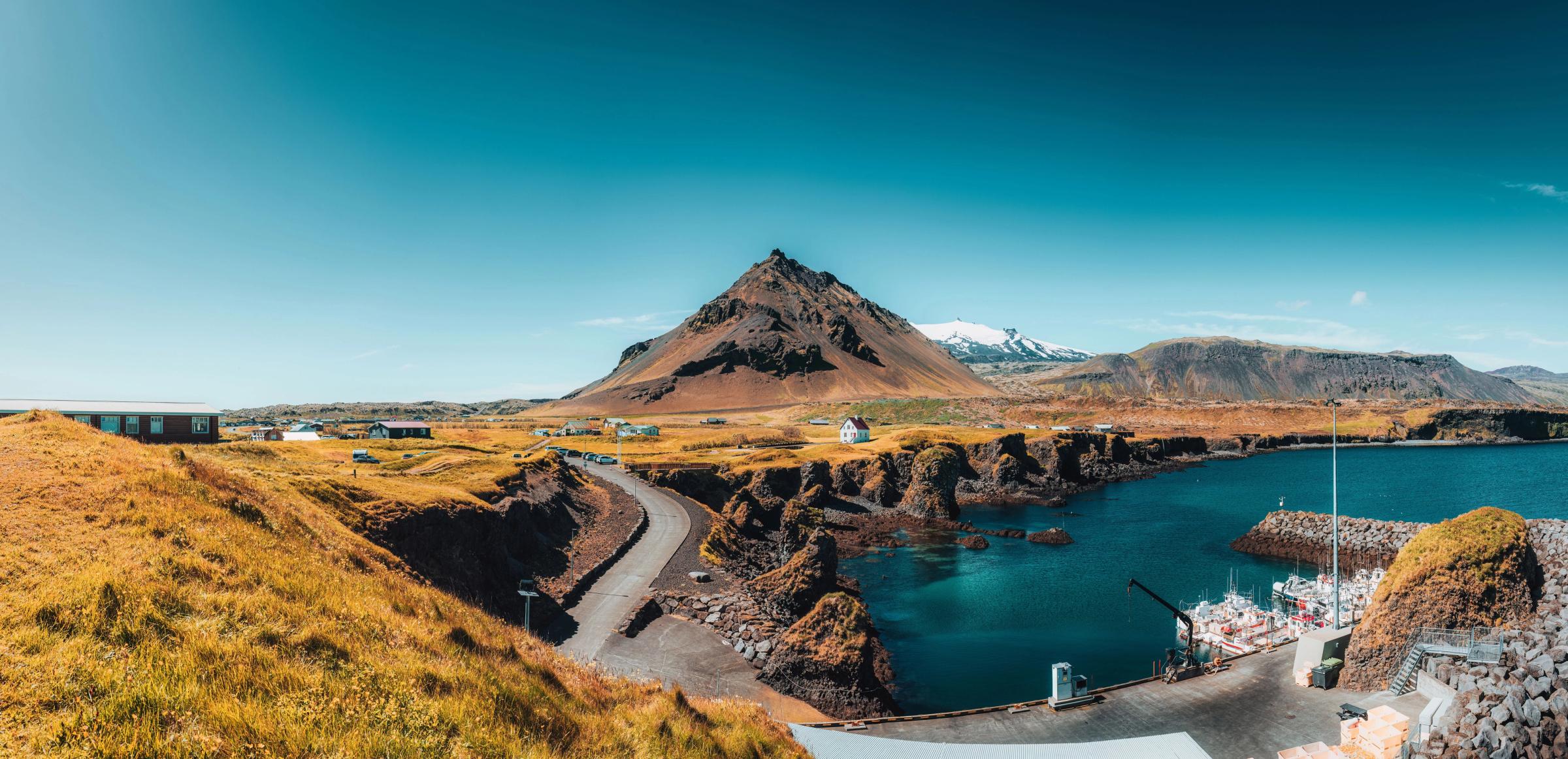 there is a mountain in the background and a lake in the foreground .