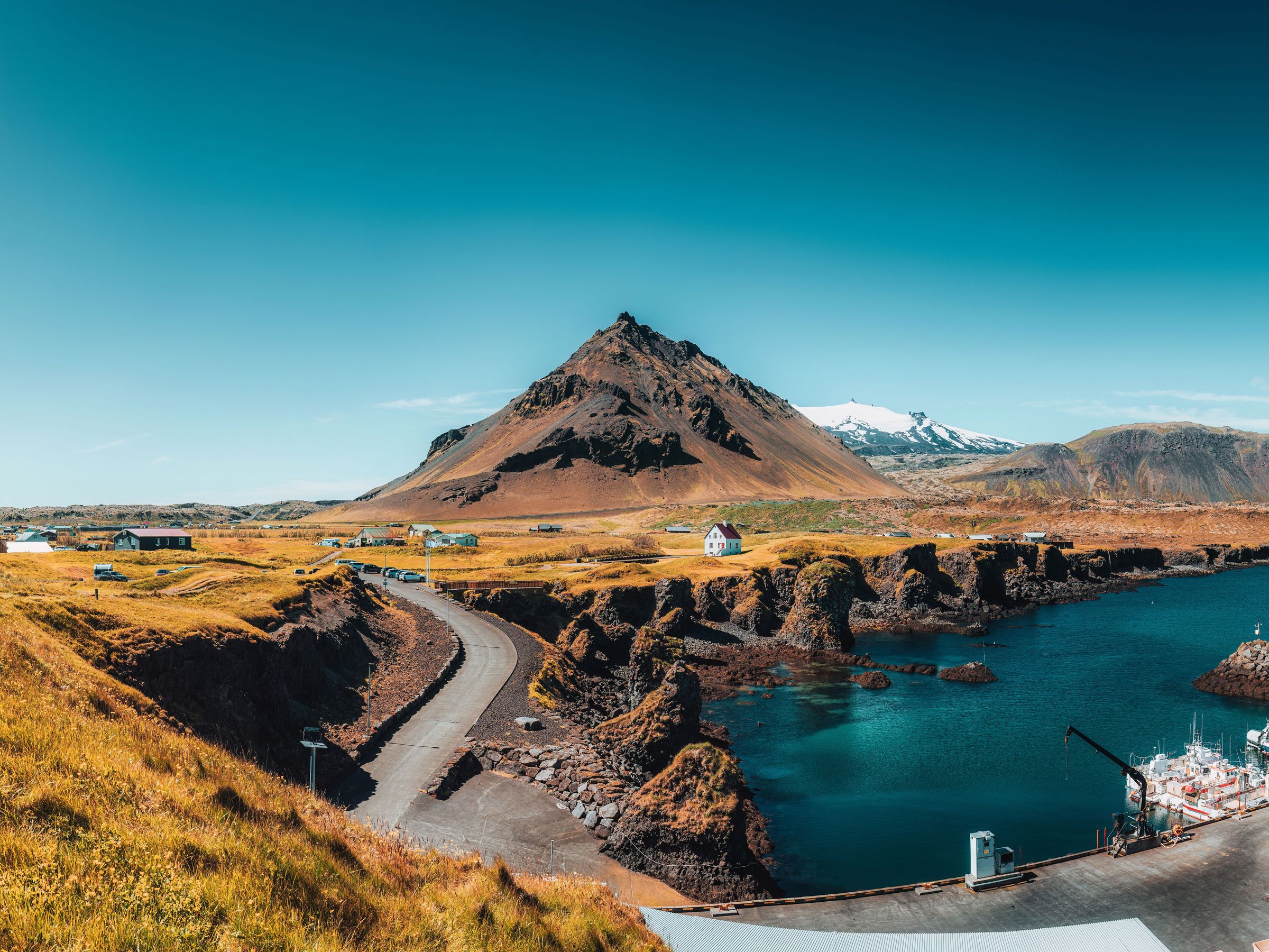 there is a mountain in the background and a lake in the foreground .