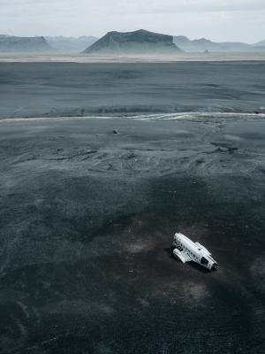 an aerial view of an airplane sitting in the middle of a desert .