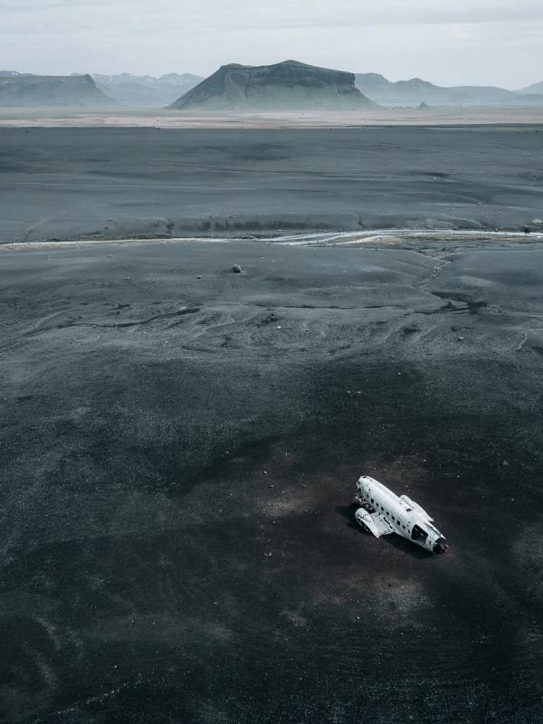an aerial view of an airplane sitting in the middle of a desert .